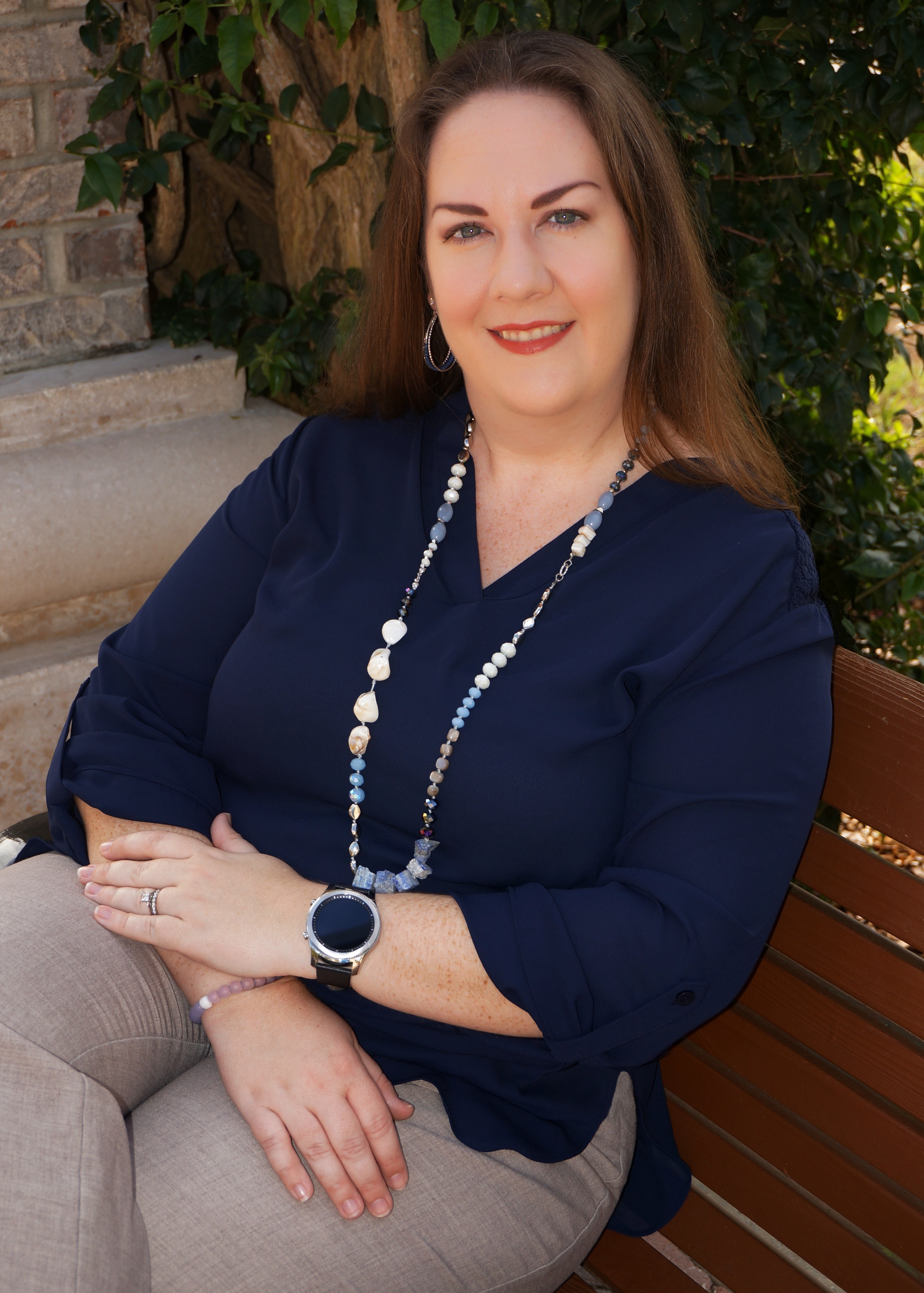 Rebecca Stone, LMHC-QS sitting on a bench